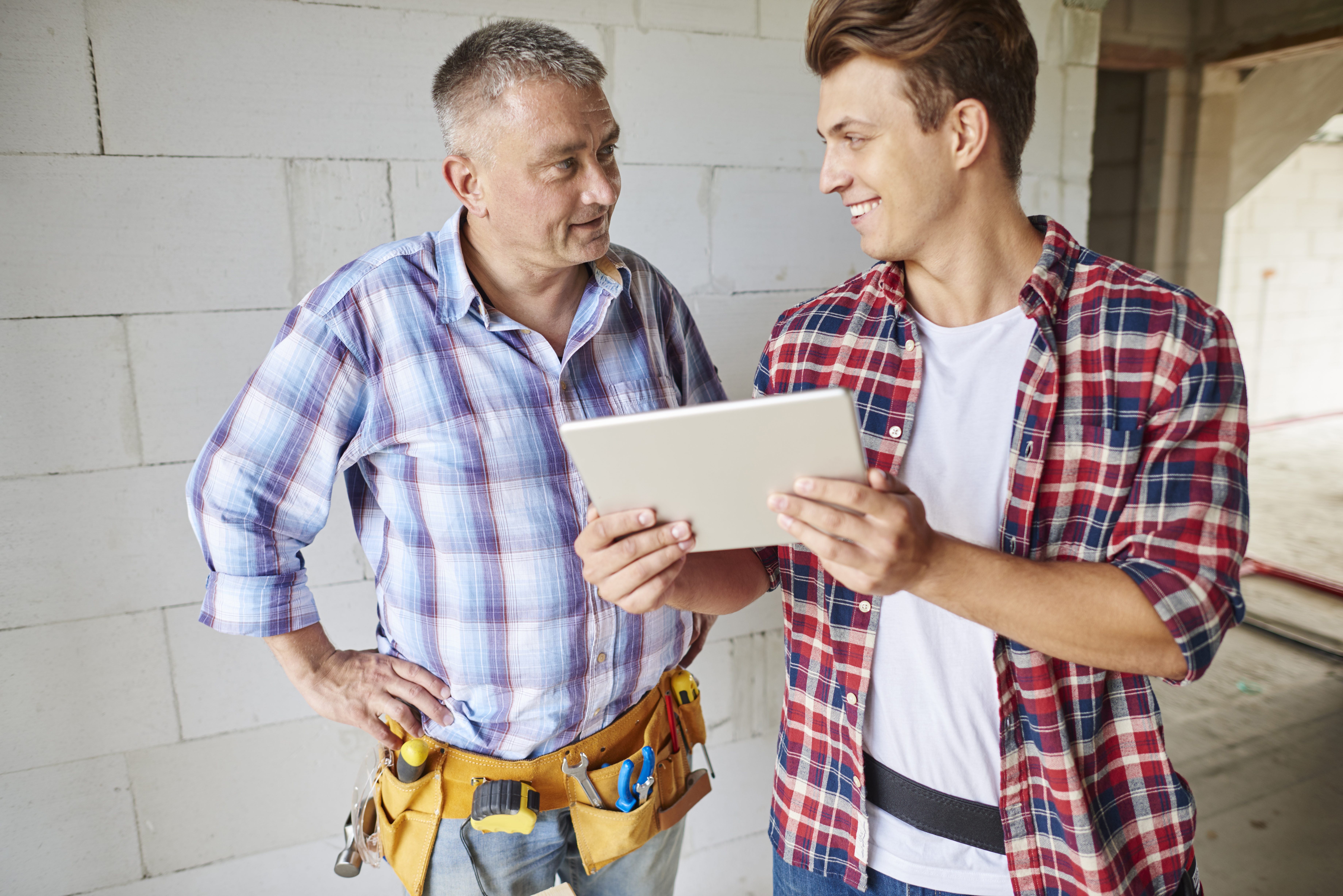 close up experienced carpenter his younger employee